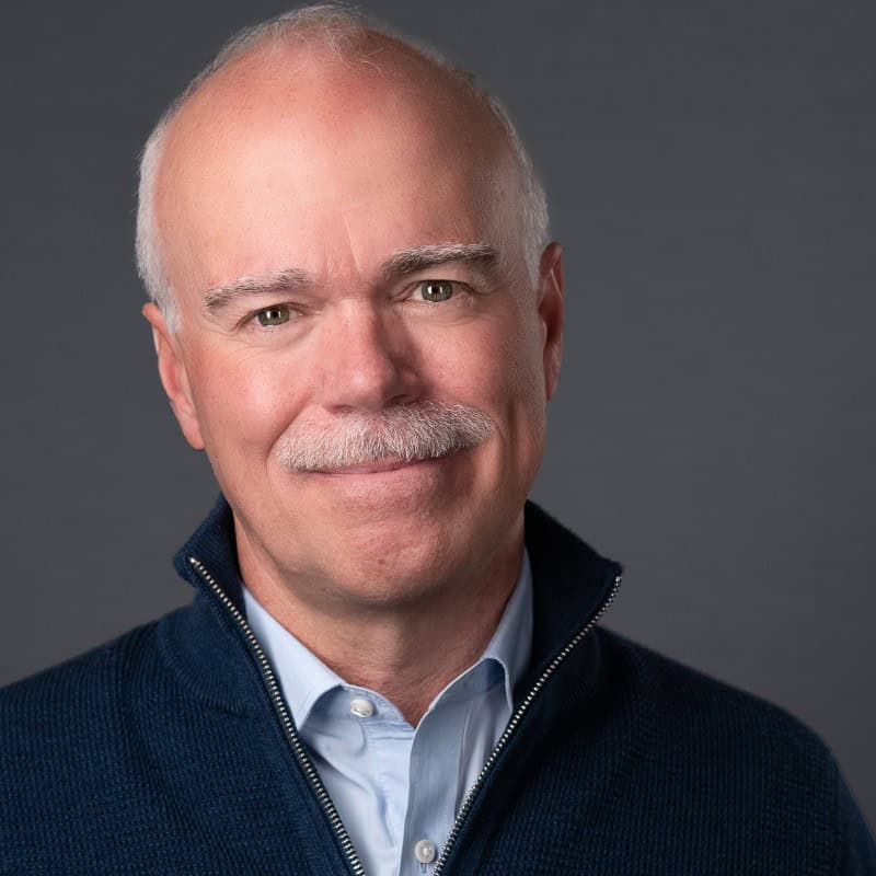 Smiling older man in blue sweater portrait