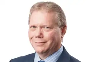 Headshot of middle-aged man in suit and tie