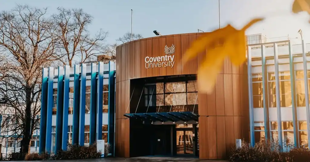 Exterior view of Coventry University with modern architecture and blue accents.