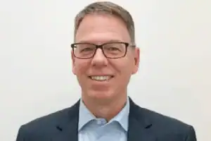 Smiling man wearing glasses and business suit