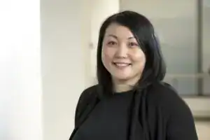 Smiling woman in black top indoors