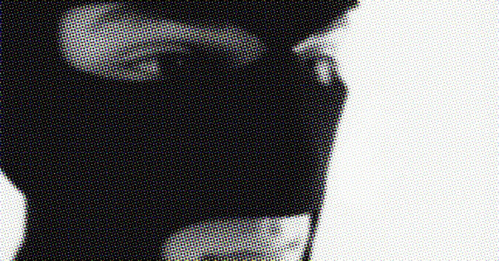 Close-up of a person in a hoodie with a mask, symbolizing cybersecurity.