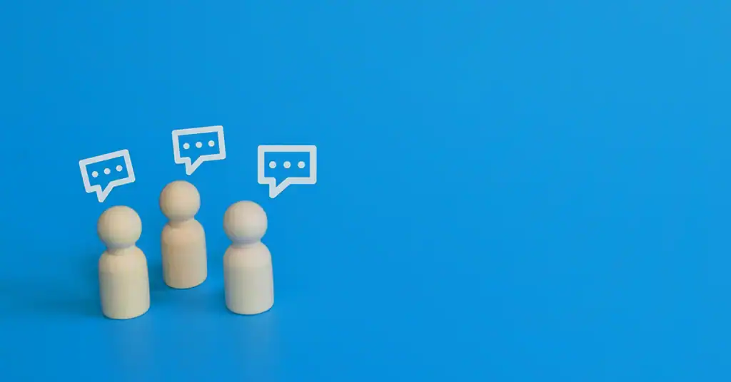 Three wooden figures with speech bubbles on a blue background.