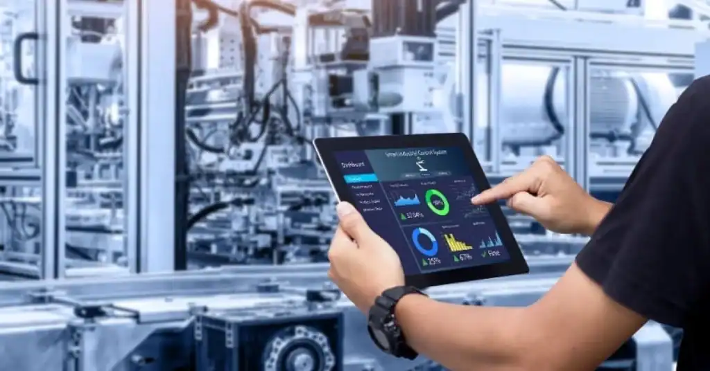 Technician monitoring industrial automation system on tablet