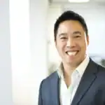 Smiling businessman in a navy suit in an office