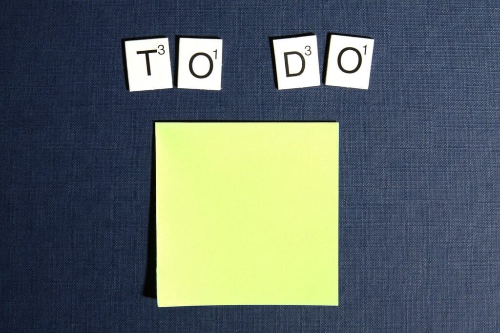 Letter tiles spelling "TO DO" above yellow sticky note